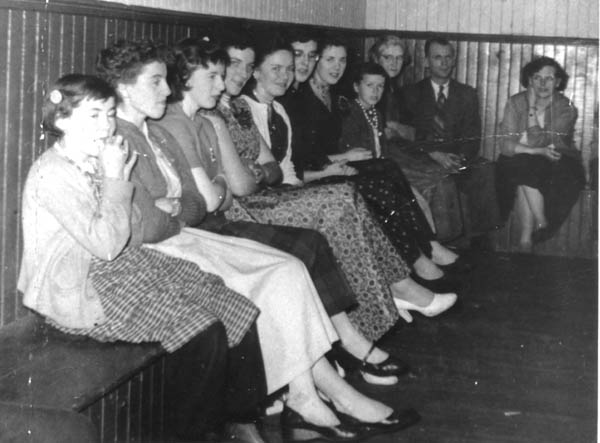 084: A dance at Red Island. l-r Regina Rose, Teresa Whelan, Imelda Ryan, Marie Counsel,  Gwen Carroll, Marie Ryan (glasses), Angela Ryan, Alice Bishop, Josie (Barry) Carroll,  Jim McCarthy, Norah McCarthy. (circa 1954-1956) [courtesy of Betty (Carroll) Spurvey]  - Regina daughter of Raymond Rose &amp;amp; Catherine Ryan; Teresa daughter of Leo Whelan &amp;amp;  Eliz Bishop; Imelda daughter of Jeremiah Ryan &amp;amp; Josie Lambe; Marie daughter of Michael  Counsel &amp;amp; Mary Anne Barry; Gwen daughter of Michael Carroll &amp;amp; Josie Barry; Marie  daughter of Joseph Ryan &amp;amp; Ursula Barry; Angela daughter of Michael Ryan &amp;amp; Petronella  Whelan; Alice daughter of Ambrose Bishop &amp;amp; Mary Mulrooney; Josie (Barry) Carroll daughter  of William Barry &amp;amp; Margaret Murphy; Jim McCarthy son of James McCarthy &amp;amp; Mary Ellen  Barry; Norah daughter of Thomas McCarthy &amp;amp; Margaret Whelan